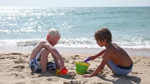 Children two little boys playing on the beach on summer holidays.  Stock Footage 265869953
