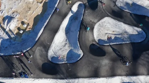 Children, unrecognizable, ride bicycles on pump track still under 스톡 동영상 122075146