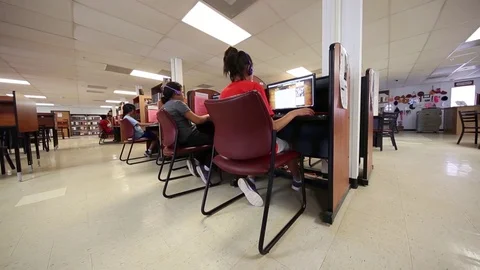 Children use computers at South Texas Residential Family Detention Centre Stock Footage 93544623