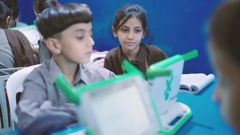 Children use small laptops and tablets in a Karachi classroom, Pakistan Stock Footage 329225609