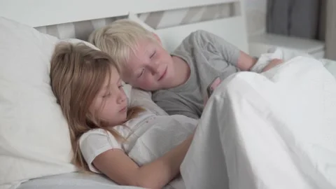 Children use their mobile phone in the morning in bed Stock Footage 164564625