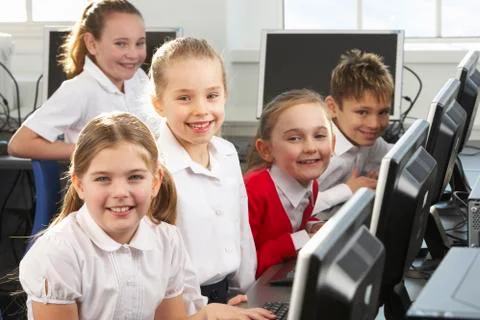 Children using computers in school class Stock Photos