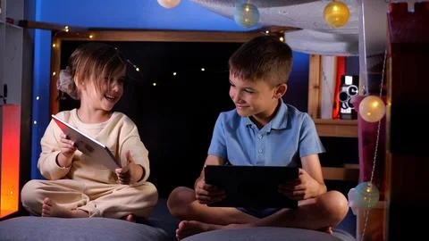 Children using digital tablet computers, playing games, watching cartoons Stock Photos