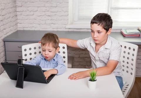 Children using gadgets to study. Education distance learning for kids. Foto stock