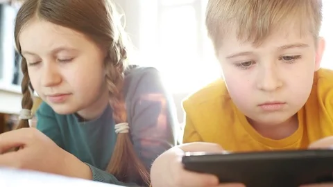 Children using smartphone together browsing online.  Stock Footage 84314107