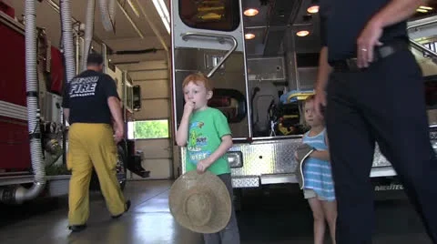Children visit fire station, fireman Stock Footage 24917239