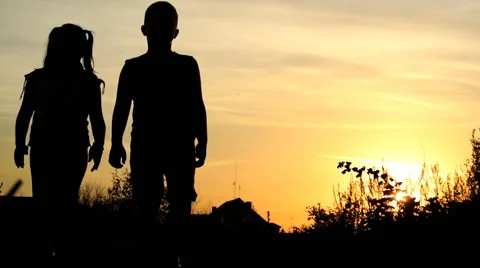 Children walk along the path. Boy and girl at sunset background  Stock Footage 55255000