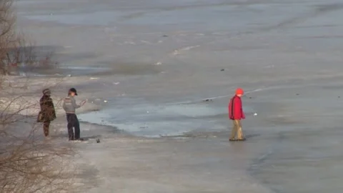 Children walk on the ice on the river in the spring Stock Footage 150122825