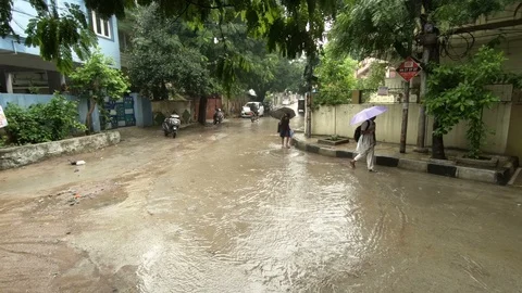 Children walk to school in rain Stock Footage 94903637