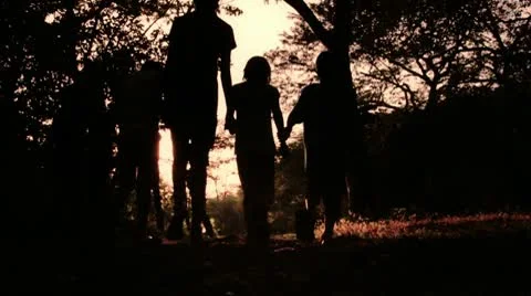 Children Walking Holding Hands into Sunset Stock Footage