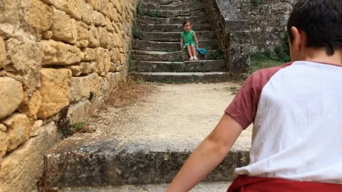 Children walking up old steps in medieval village Stock-Footage 98631004
