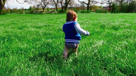 Children walking in a pretty meadow in Springtime Video stock 64288210