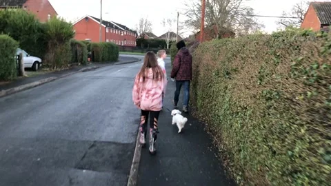 Children walking in a resdential street Stock Footage 146239402