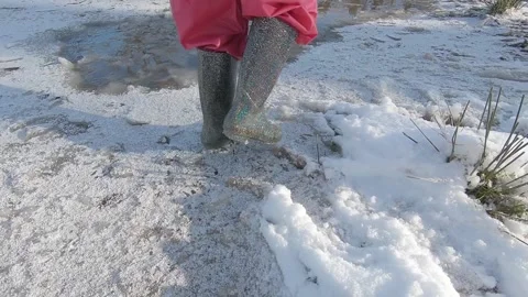 Children walking on thin ice with snow Stock Footage 147346139