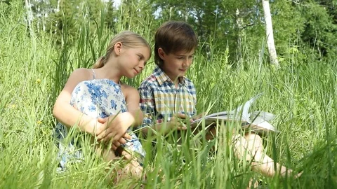 Children watching book Stock Footage 112121759