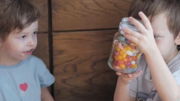 Children watching a candy jar Stock Footage 85595148