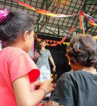 Children watching a dance performance at the setu babakan cultural festival. Foto stock