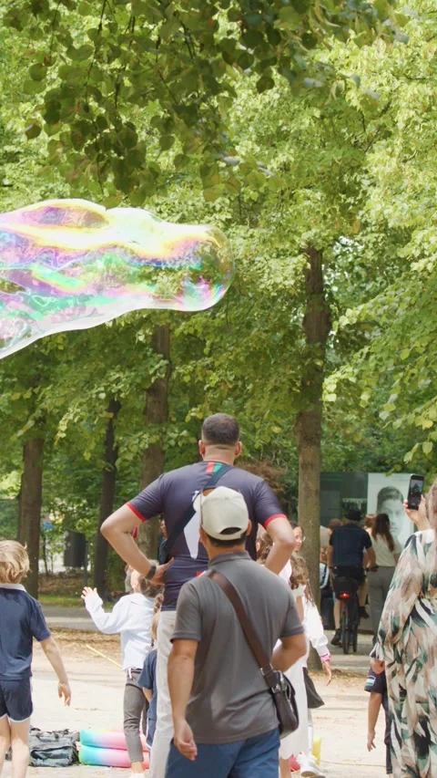 Children Watching Giant Soap Bubbles in Berlin Park Stock Footage 315086735