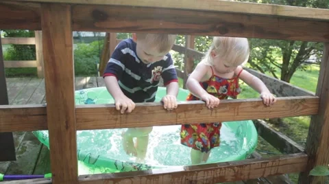 Children water stomp in a kiddie pool Stock Footage 40205978