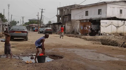 Children watering road, Douala Stock Footage 80424749