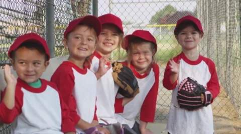 Children waving while playing baseball Stock Footage 67348481