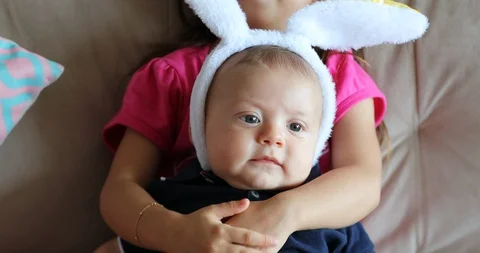 Children wearing bunny ears for easter holiday cute baby brother and sister Stock Footage 116976578