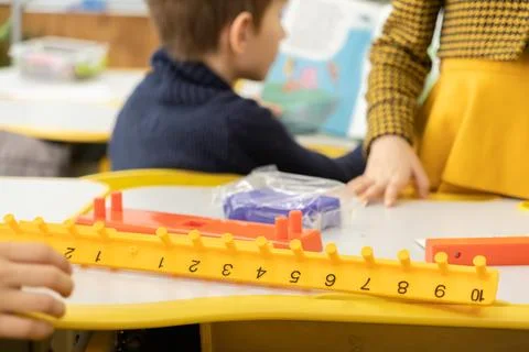 Children working with colorful math counting sticks on a classroom table to.. Stockfoto's