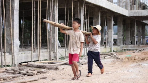 Children working at construction site.  Poor children are forced to work in.. Stock Footage 336941928