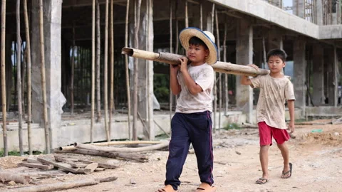 Children working at construction site.  Poor children are forced to work in.. Stock Footage 336941996