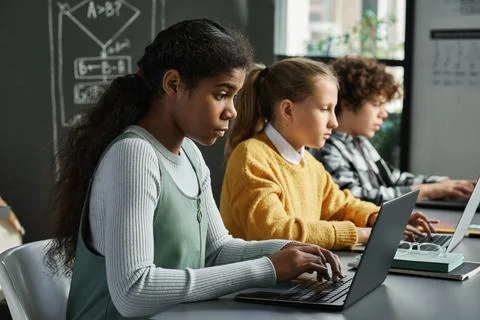 Children working with new software on computers Stock Photos