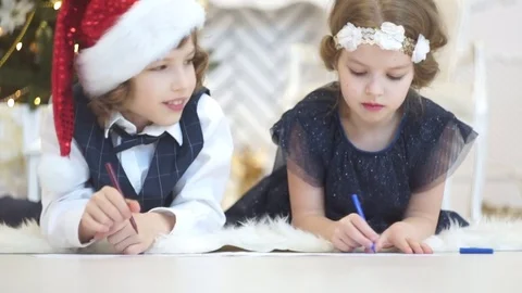 Children write letters to Santa Claus. To children it is cheerful. Stock Footage 70780946