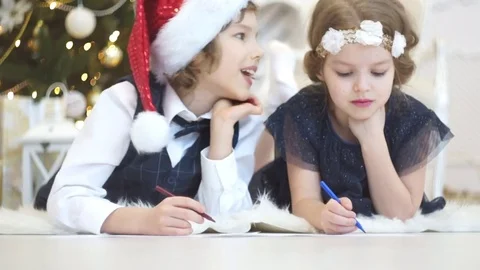 Children write letters to Santa Claus. To children it is cheerful. Stock Footage 70781946