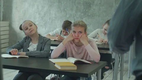 Children writing notes in class during lesson Видео 77735777
