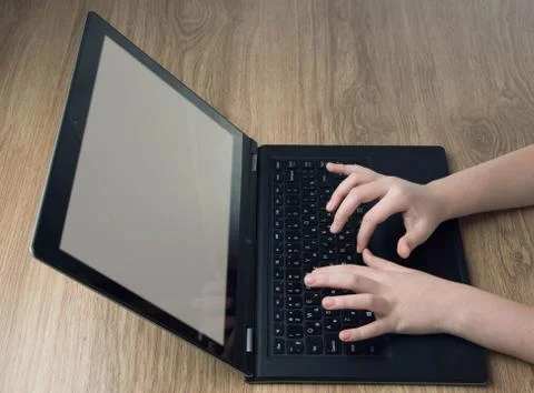 Children&amp;#39;s hands typing on computer Stock Photos