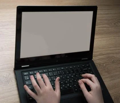 Children&amp;#39;s hands typing on computer Stock Photos