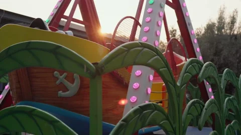 Children's attraction ship with luminous bulbs at sunset time Stock Footage 201113705