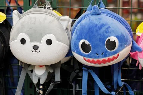 Children's backpack in the shape of wolf and shark animals Stock Photos