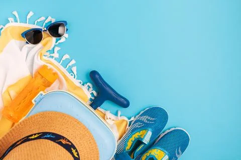 Children's beach essentials including a hat, sunglasses, water shoes, suitc.. Stock Photos