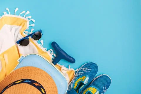 Children's beach essentials including a hat, sunglasses, water shoes, suitc.. Stock Photos