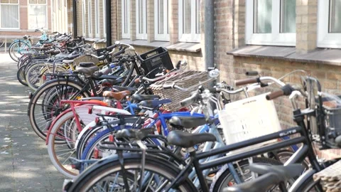 Children's Bikes Parked in Front of Building Stock Footage 148374170