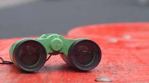 Children's binoculars lying on a bench Stock Photos