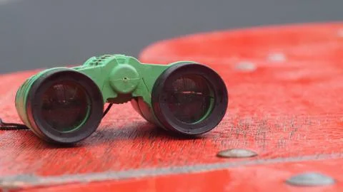 Children's binoculars lying on a bench Stock Photos