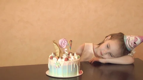 Children's birthday party. Little girl looking at the cake. family celebration. Stock Footage