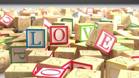 Children's blocks falling to spell the word Love - Falling in Love Stock Footage