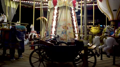 Children's carousel with horses at night Stock Footage 154583101