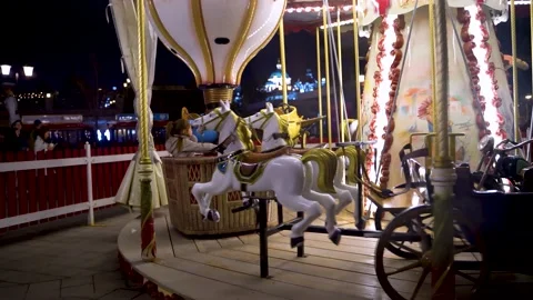 Children's carousel with horses at night Stock Footage 154583576