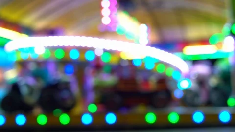 Children's carousel at night with blinking lights. blurry video. Stock Footage 118322179