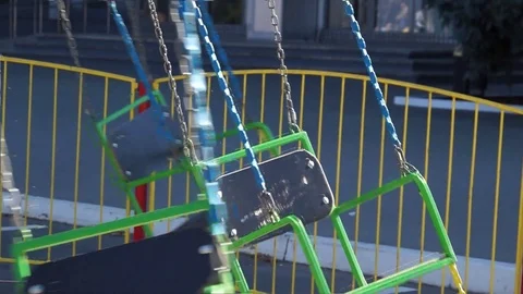 Children's carousel in the park. In slow motion. Stock Footage 100601039