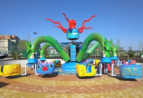 Children's carousel in the shape of a multi-headed dragon Stock Photos