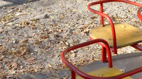 Children's carousel spinning on playground Stockbeeldmateriaal 98264538